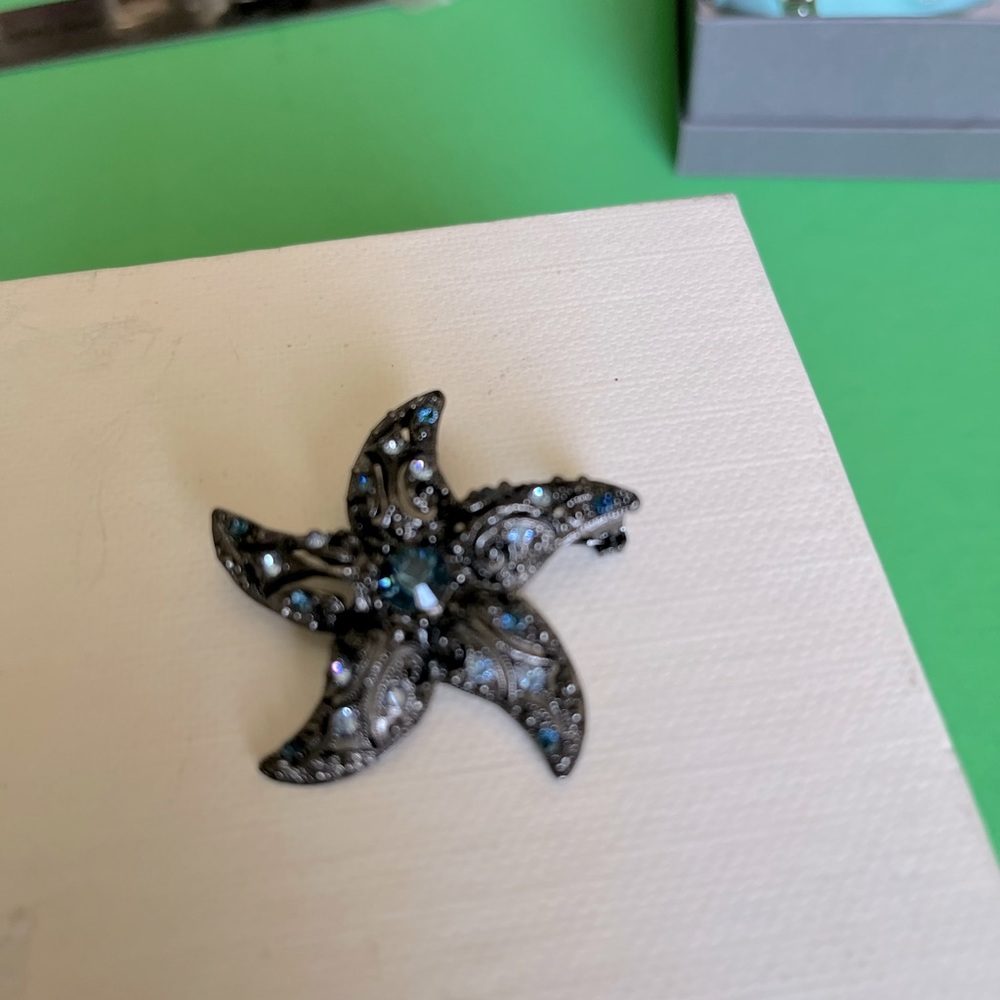 JEWELRY. Blue colored, costume; faux jeweled star-shaped brooch.